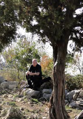 Fr. Ray praying on Cross Mountain