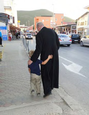 Fr. Ray with a little friend in Medjugorje